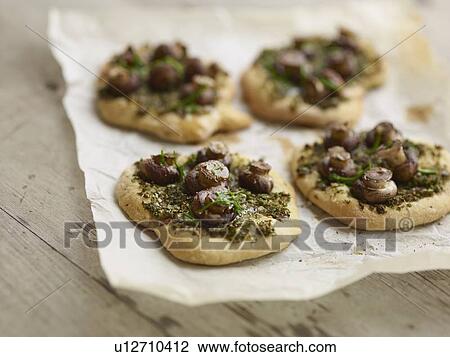 Stock Image - Close up of mushroom pesto pastries. Fotosearch