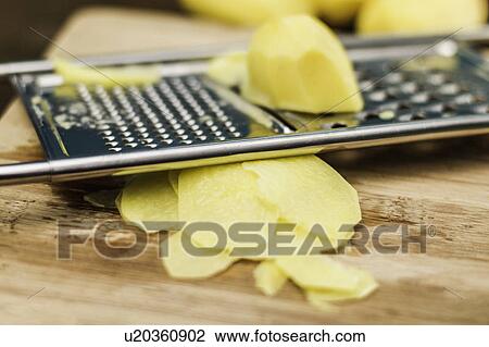 Close up of potato on grater View Large Photo Image Stock Image - Close up of potato on grater. Fotosearch