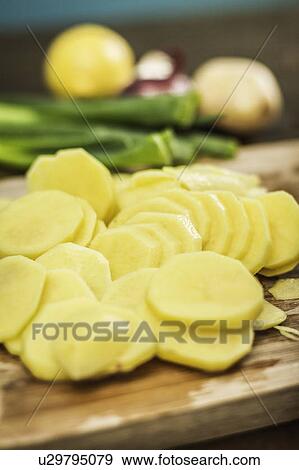 Close up of sliced potato on board View Large Photo Image Stock Photo - Close up of sliced potato on board. Fotosearch