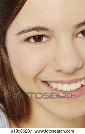 Stock Photo - Close up of teenage girls smiling face. Fotosearch