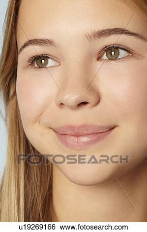 Stock Photograph - Close up of teenage girls smiling face. Fotosearch