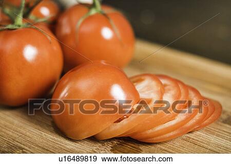 Close up of whole and sliced tomato View Large Photo Image Stock Photo - Close up of whole and sliced tomato. Fotosearch