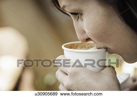 Close up of woman drinking cup of coffee View Large Photo Image Stock Photo - Close up of woman drinking cup of coffee. Fotosearch