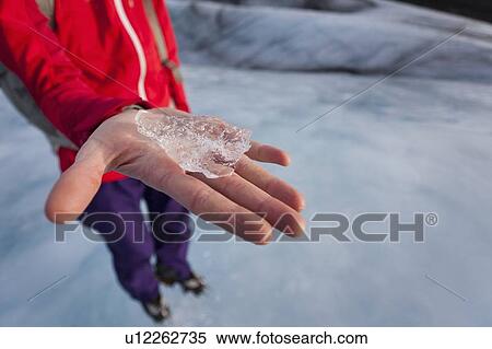 Close up of woman holding piece of ice View Large Photo Image Stock Photography - Close up of woman holding piece of ice. Fotosearch