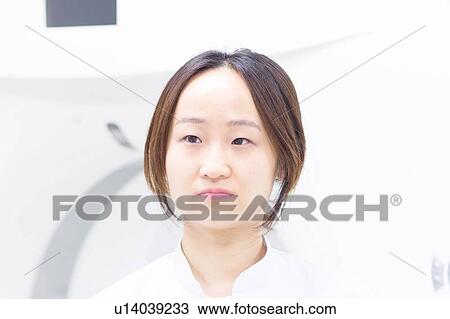 Stock Image - Close up of womans serious face. Fotosearch