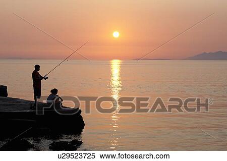 Couple fishing off pier at sunset View Large Photo Image Stock Photography - Couple fishing off pier at sunset. Fotosearch