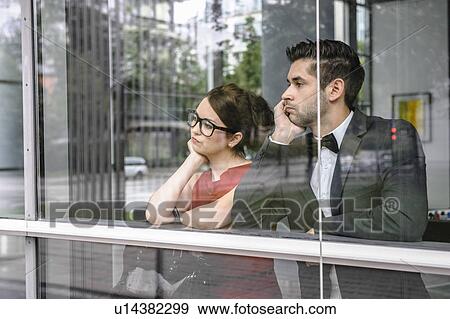 Couple looking out window View Large Photo Image Stock Photo - Couple looking out window. Fotosearch