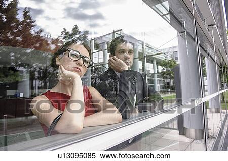 Stock Photography - Couple looking out window. Fotosearch