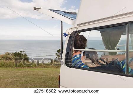 Couple relaxing together in trailer View Large Photo Image Stock Image - Couple relaxing together in trailer. Fotosearch