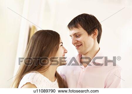 Couple smiling together indoors View Large Photo Image Stock Image - Couple smiling together indoors. Fotosearch