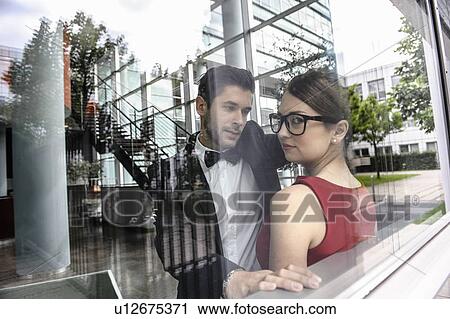 Stock Image - Couple standing by window. Fotosearch