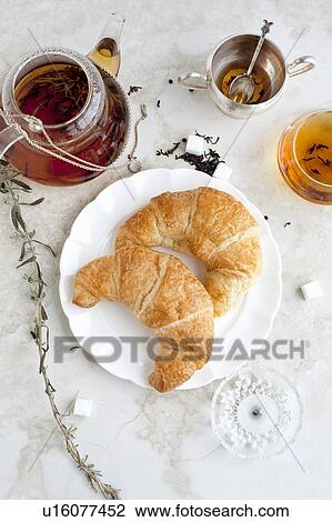 Croissants, honey and tea on table View Large Photo Image Stock Image - Croissants, honey and tea on table. Fotosearch