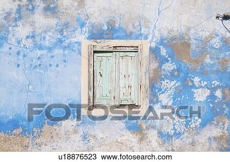 Stock Image - Dilapidated window, shutters and wall. Fotosearch