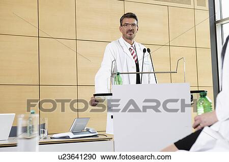 Doctor giving talk in conference room View Large Photo Image Stock Image - Doctor giving talk in conference room. Fotosearch