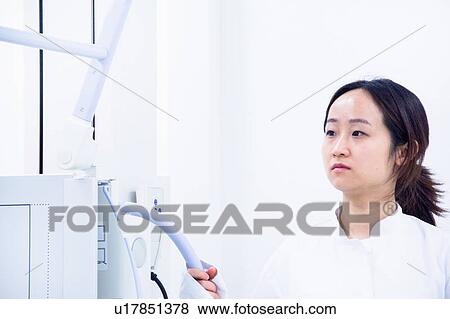 Stock Photo - Doctor operating CT scanner in hospital. Fotosearch
