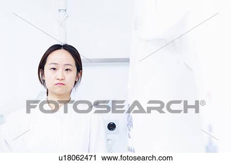 Stock Image - Doctor standing in hospital. Fotosearch