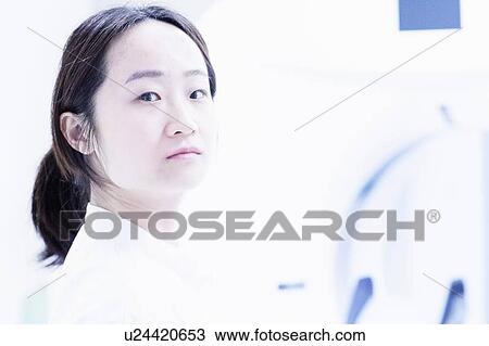 Stock Image - Doctor standing in hospital. Fotosearch