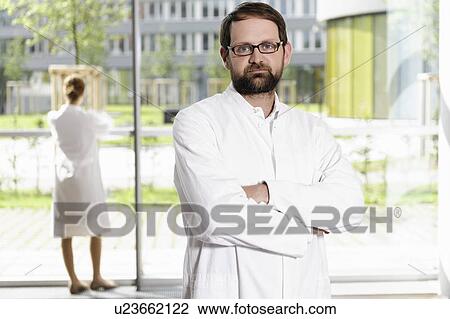 Doctor standing with arms crossed View Large Photo Image Stock Image - Doctor standing with arms crossed. Fotosearch