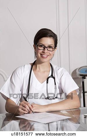 Stock Photo - Doctor taking notes in office. Fotosearch