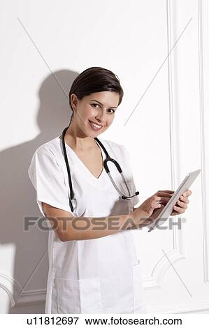 Doctor using tablet computer in office View Large Photo Image Stock Photo - Doctor using tablet computer in office. Fotosearch
