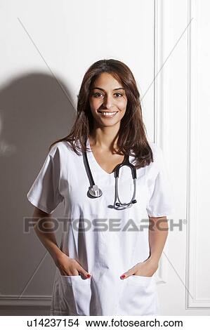Doctor wearing stethoscope in office View Large Photo Image Picture - Doctor wearing stethoscope in office. Fotosearch