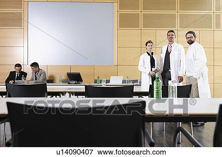 Stock Photo - Doctors and businessmen in meeting room. Fotosearch
