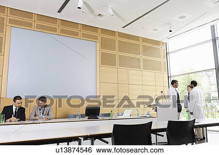 Doctors and businessmen in meeting room View Large Photo Image Stock Photograph - Doctors and businessmen in meeting room. Fotosearch
