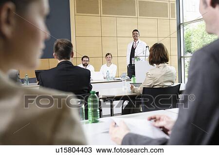 Doctors giving talk in conference room View Large Photo Image Stock Image - Doctors giving talk in conference room. Fotosearch