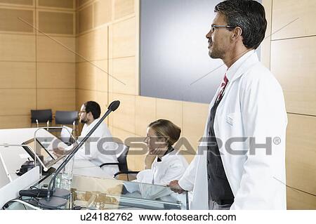 Doctors giving talk in conference room View Large Photo Image Stock Image - Doctors giving talk in conference room. Fotosearch