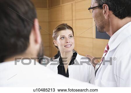 Doctors talking in conference room View Large Photo Image Stock Image - Doctors talking in conference room. Fotosearch