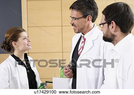 Doctors talking in conference room View Large Photo Image Stock Image - Doctors talking in conference room. Fotosearch
