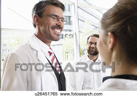 Doctors talking in conference room View Large Photo Image Stock Photography - Doctors talking in conference room. Fotosearch