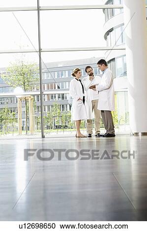 Doctors talking in hallway View Large Photo Image Stock Image - Doctors talking in hallway. Fotosearch