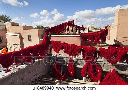 Stock Image - Dyed wool drying on lines. Fotosearch