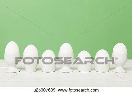 Eggs in various egg cups View Large Photo Image Stock Photo - Eggs in various egg cups. Fotosearch