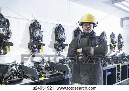 Firefighter standing in training room View Large Photo Image Stock Image - Firefighter standing in training room. Fotosearch
