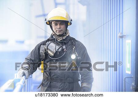 Firefighter standing on platform View Large Photo Image Stock Image - Firefighter standing on platform. Fotosearch