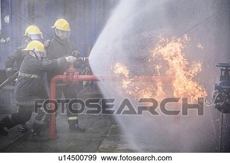 Stock Photo - Firefighters in simulation training. Fotosearch