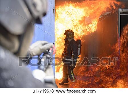 Stock Photo - Firefighters in simulation training. Fotosearch
