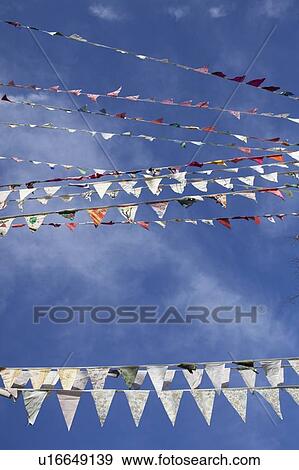 Stock Photo - Flags flying against blue sky. Fotosearch