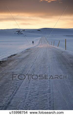 Picture - Frozen road in snowy landscape. Fotosearch