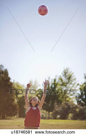 Girl playing with soccer ball in field View Large Photo Image Stock Image - Girl playing with soccer ball in field. Fotosearch