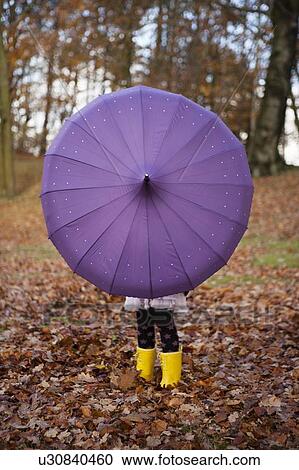 Girl playing with umbrella in park View Large Photo Image Stock Image - Girl playing with umbrella in park. Fotosearch