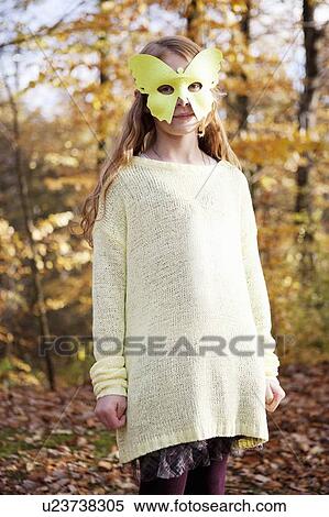 Girl wearing butterfly mask in park View Large Photo Image Stock Photography - Girl wearing butterfly mask in park. Fotosearch