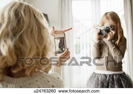 Girls taking pictures of each other View Large Photo Image Stock Image - Girls taking pictures of each other. Fotosearch