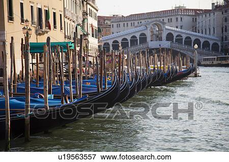 Stock Photo - Gondolas docked on Venice canal. Fotosearch