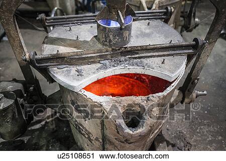 Stock Image - Heated metal flask in foundry. Fotosearch