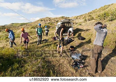 Stock Image - Hikers putting on safety equipment. Fotosearch
