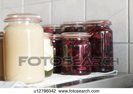 Jars of preserves resting in kitchen View Large Photo Image Stock Image - Jars of preserves resting in kitchen. Fotosearch