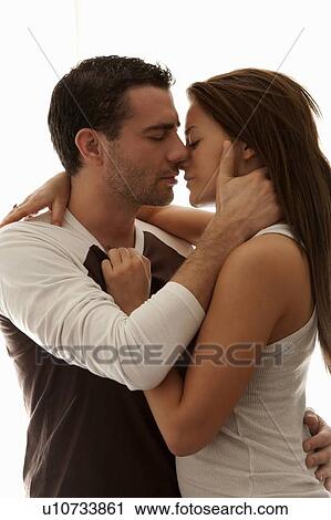Stock Image - Kissing couple hugging. Fotosearch